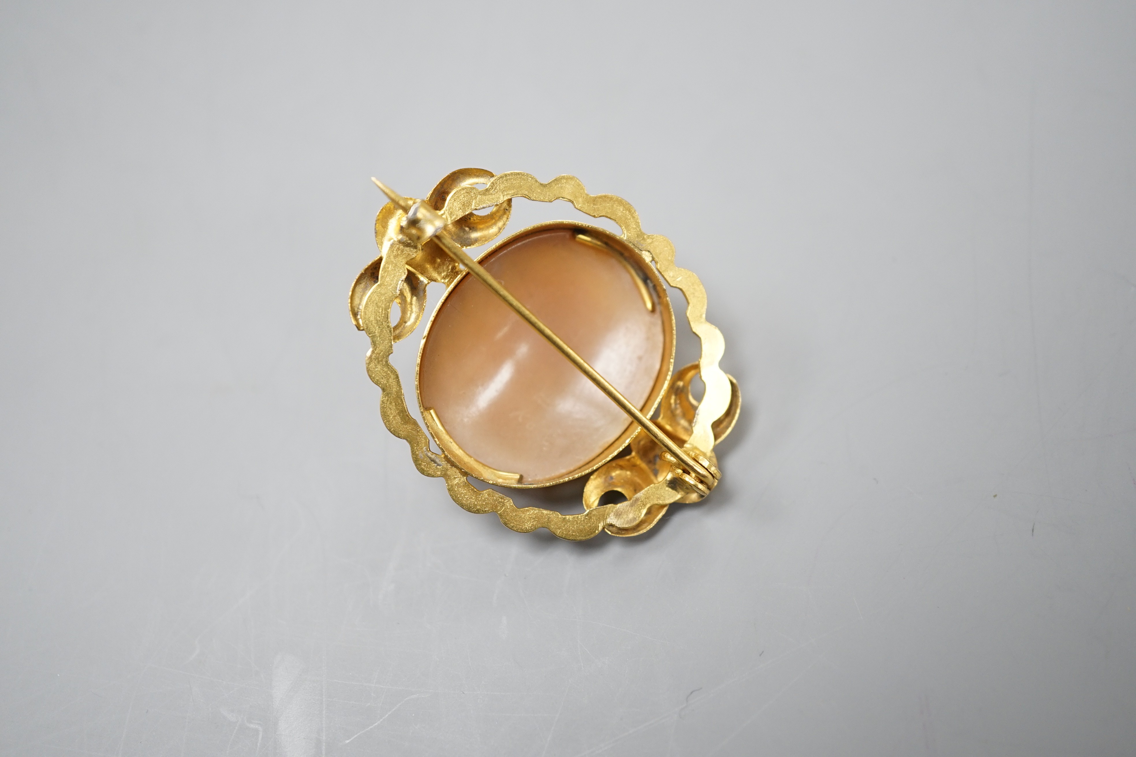 An early 20th century yellow metal mounted oval cameo shell brooch, carved with with the bust of a gentleman to sinister, 37mm, gross 7.6 grams.